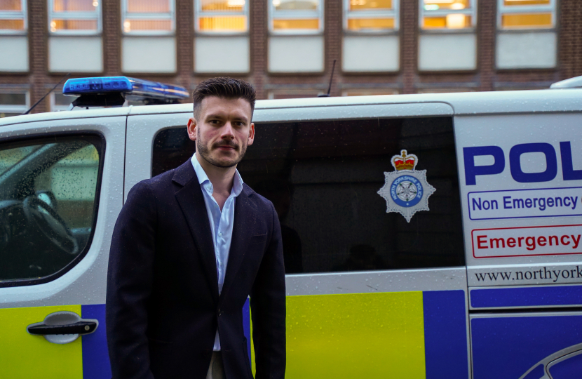 Keane Duncan with a police van