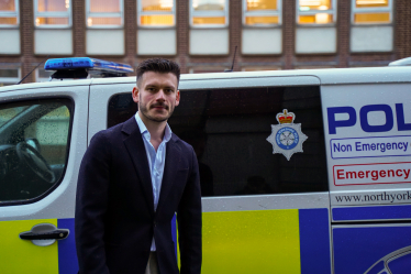 Keane Duncan with a police van